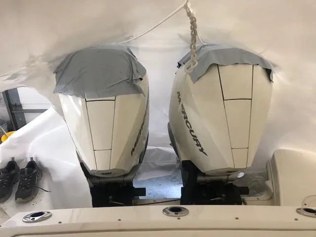 Slide: The Image of Twin Mercury outboard engines on a 2022 Boston Whaler 280 Vantage, covered for protection. - 9