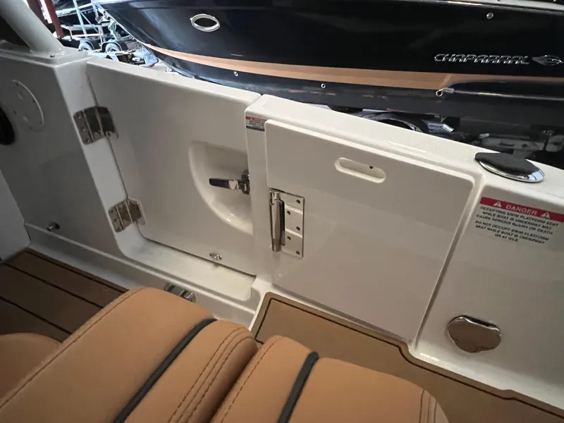 Slide: The Image of 2023 Chaparral 280 OSX boat interior with tan seating and white door. - 5