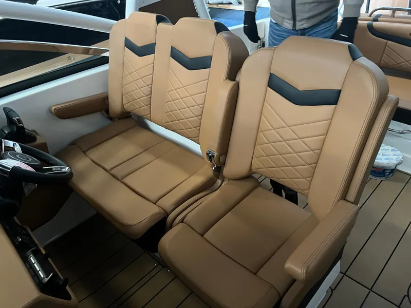 Slide: The Image of 2023 Chaparral 280 OSX boat interior with tan leather seating and modern design. - 6