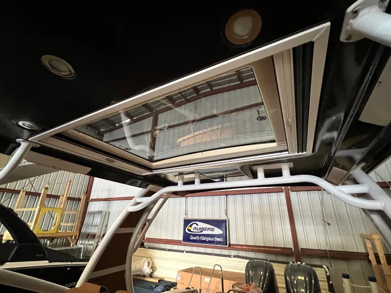Slide: The Image of 2023 Chaparral 280 OSX boat interior with sunroof and structural details. - 7