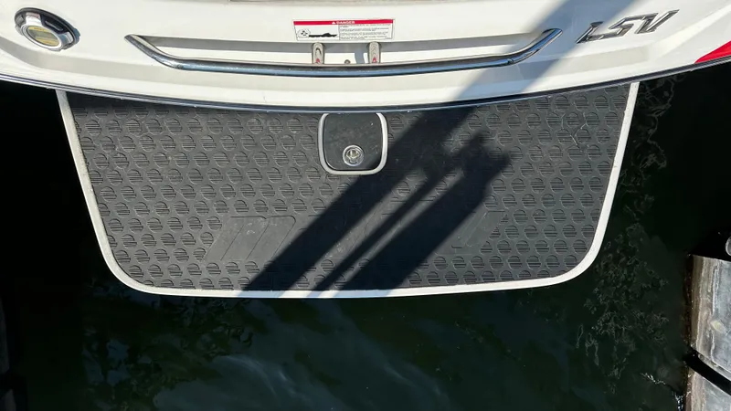 Slide: The Image of 2007 Malibu 247LSV boat swim platform above water, showing textured surface. - 5