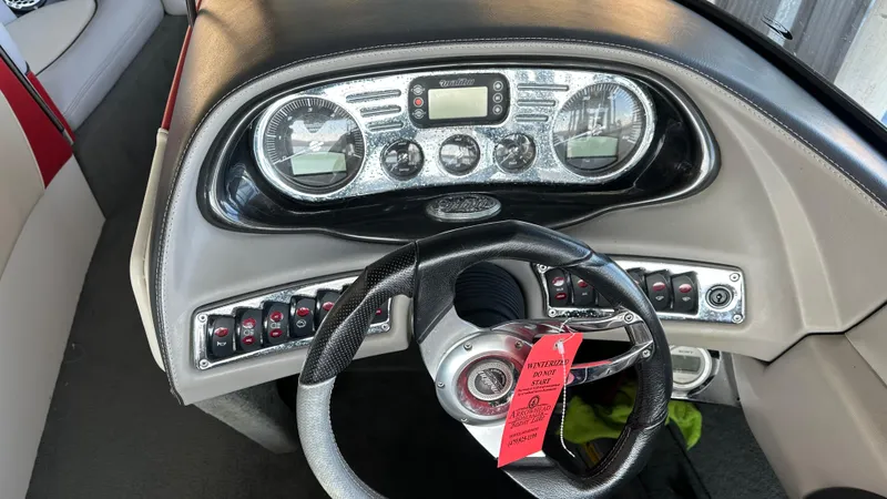 Slide: The Image of Dashboard of a 2007 Malibu 247LSV boat with steering wheel and control panel. - 6