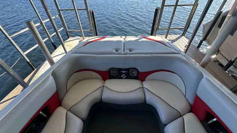 Slide: The Image of Interior of a 2007 Malibu 247LSV boat with cushioned seating and lake view. - 7