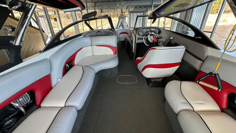 Slide: The Image of 2007 Malibu 247LSV boat interior with red and white seating, steering wheel, and dashboard. - 8