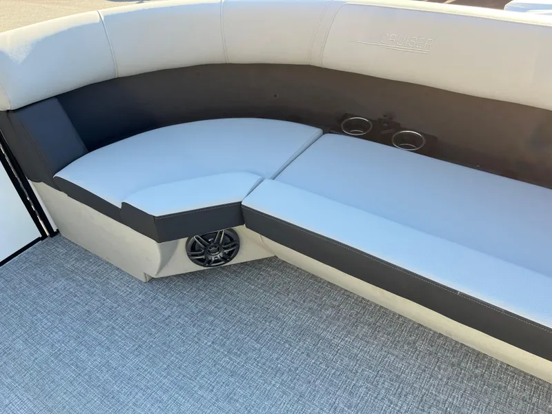 Slide: The Image of 2025 Harris Cruiser 230 boat interior with gray seating and built-in speakers. - 4