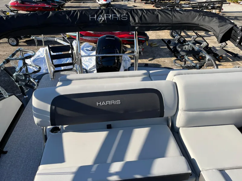 Slide: The Image of 2025 Harris Cruiser 230 boat interior with cushioned seating and canopy. - 7