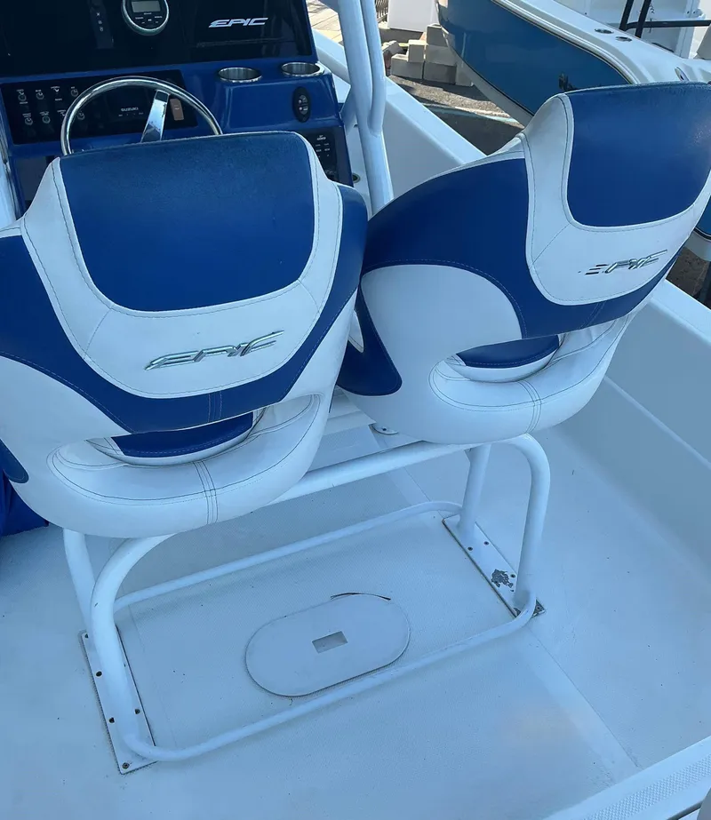 Slide: The Image of 2017 Epic 25 SC boat interior with blue and white seats and steering console. - 14