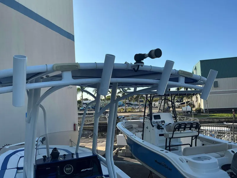 Slide: The Image of 2017 Epic 25 SC boat with rod holders and radar, docked near buildings. - 15