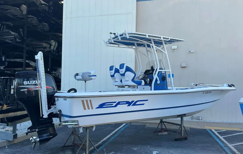 Slide: The Image of 2017 Epic 25 SC boat with Suzuki outboard motor, parked on a stand. - 3