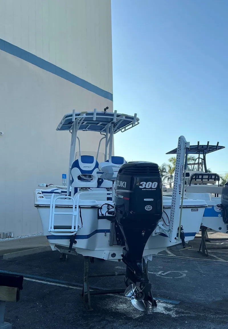 Slide: The Image of 2017 Epic 25 SC boat with Suzuki 300 outboard motor in a parking area. - 4