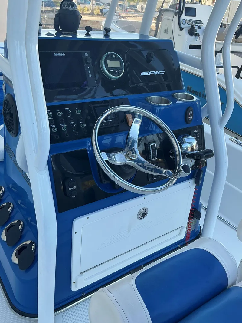 Slide: The Image of 2017 Epic 25 SC boat dashboard with steering wheel and navigation controls. - 8