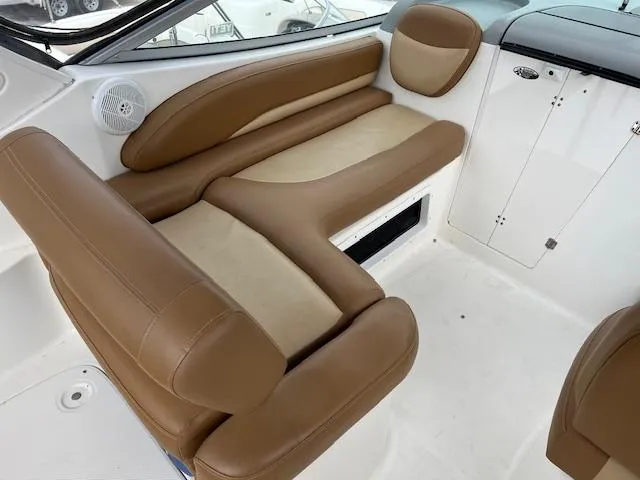 Slide: The Image of 2006 Bayliner 275 interior with tan and cream seating, showcasing comfort and style. - 10