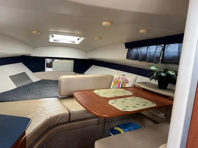 Slide: The Image of Interior of 2006 Bayliner 275 boat with seating and dining area. - 14