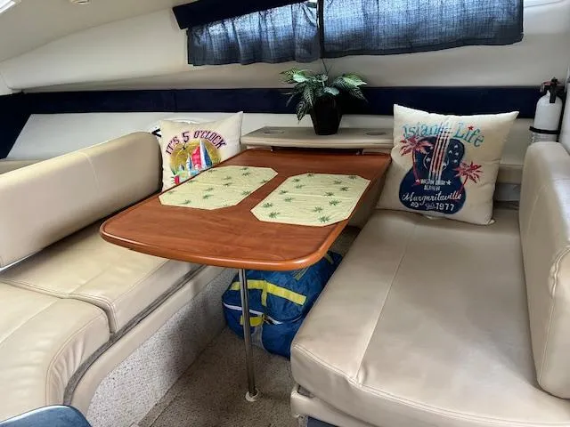 Slide: The Image of Interior of 2006 Bayliner 275 boat with cozy seating and decorative pillows. - 17