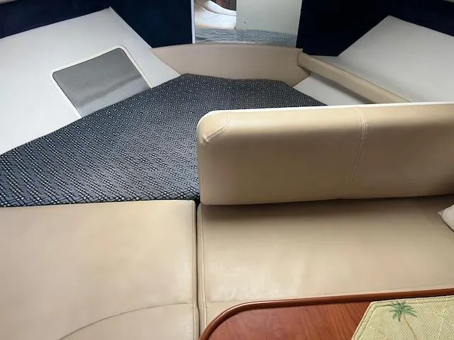 Slide: The Image of Interior of 2006 Bayliner 275 boat with beige seating and carpeted area. - 18
