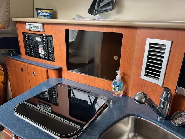 Slide: The Image of Interior of 2006 Bayliner 275 boat with kitchenette and control panel. - 19