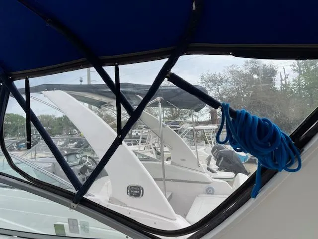 Slide: The Image of Bayliner 275 boat interior view, showcasing marina and blue rope, 2006 model. - 27