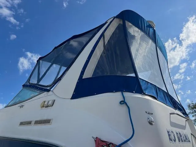 Slide: The Image of 2006 Bayliner 275 boat with blue canopy under a clear sky. - 5