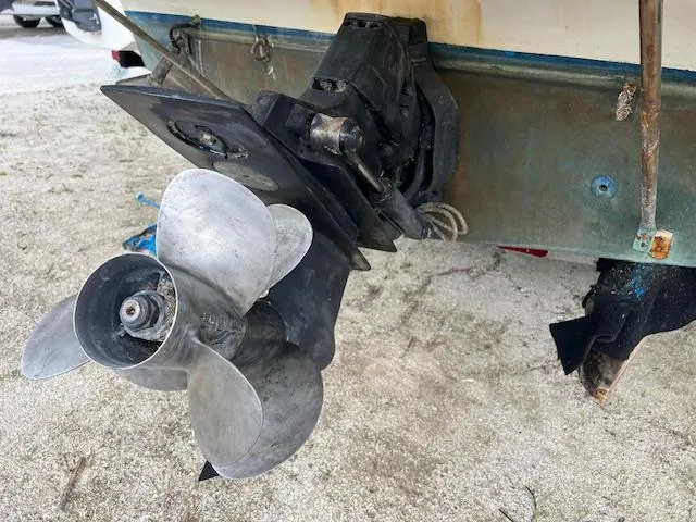 Slide: The Image of 2006 Bayliner 275 boat propeller and stern drive on sandy ground. - 8