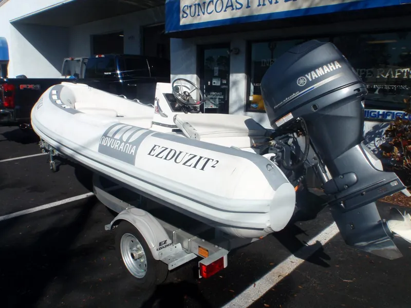 Slide: The Image of 2013 Novurania 400 DL inflatable boat with Yamaha motor on a trailer. - 2