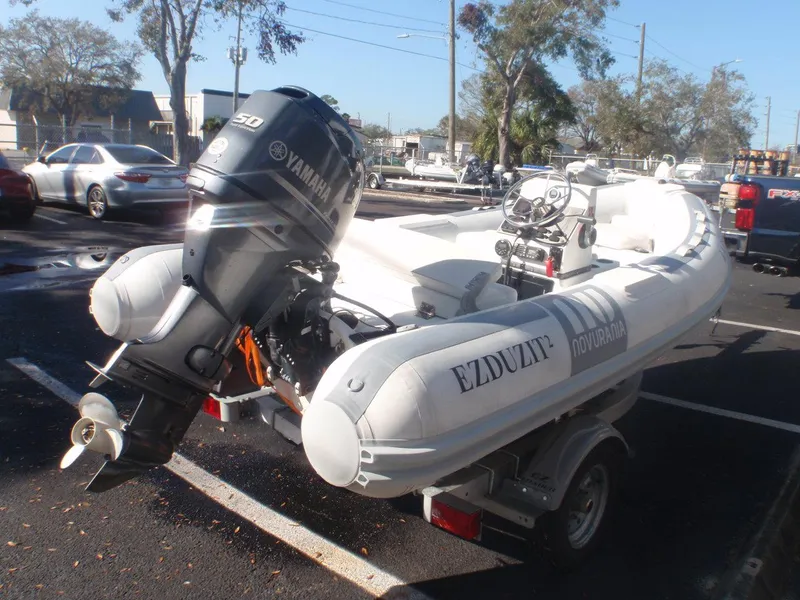 Slide: The Image of 2013 Novurania 400 DL inflatable boat with Yamaha outboard motor on a trailer. - 3