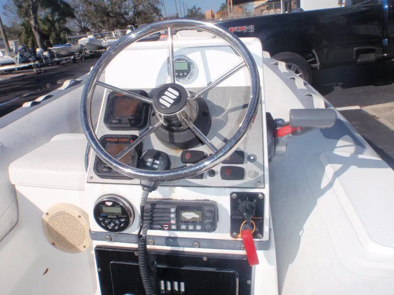 Slide: The Image of 2013 Novurania 400 DL boat dashboard with steering wheel and control panel. - 4