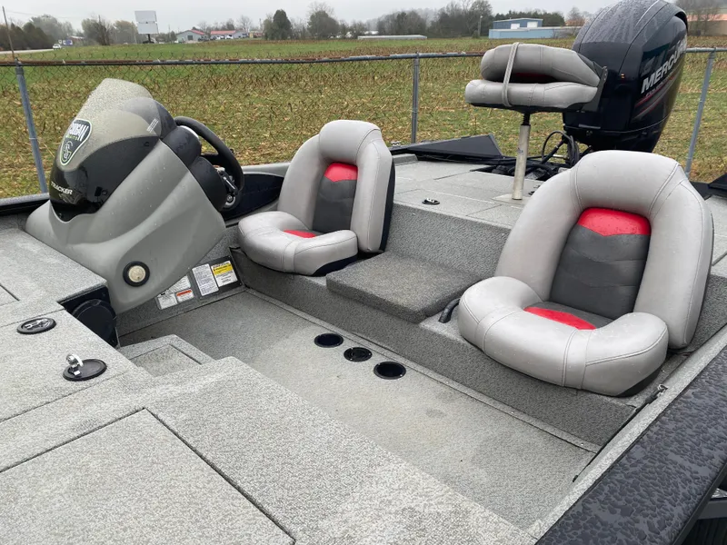 Slide: The Image of 2016 Tracker Pro Team 195 TXW boat interior with gray and red seating. - 10