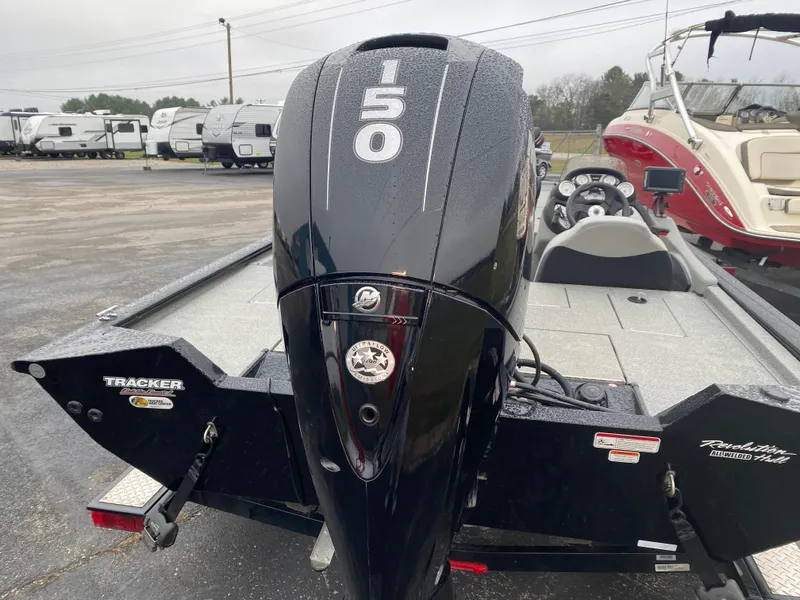 Slide: The Image of 2016 Tracker Pro Team 195 TXW boat with 150 HP engine, parked in a lot. - 13