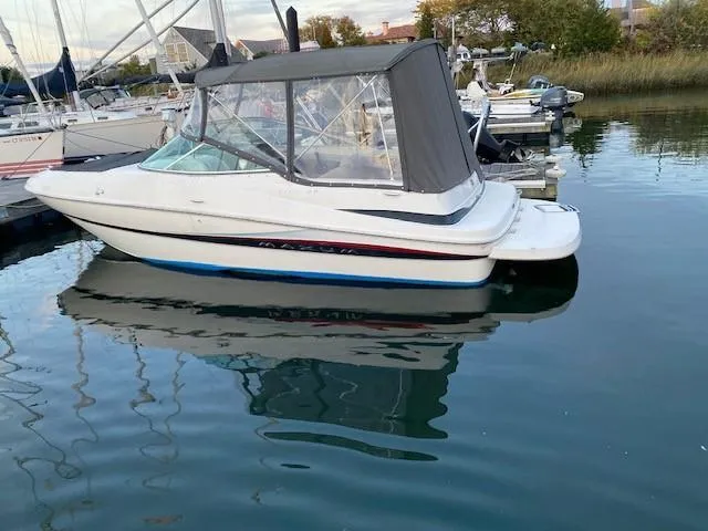 Slide: The Image of 2002 Maxum 2100 SD boat docked with canopy cover in marina. - 6