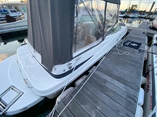 Slide: The Image of 2002 Maxum 2100 SD boat docked with canopy, side view. - 7