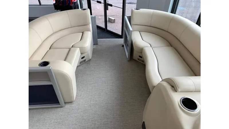 Slide: The Image of 2019 Barletta E20QC interior with beige seating and cup holders. - 11