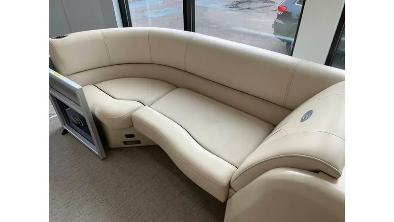 Slide: The Image of 2019 Barletta E20QC boat interior with beige curved seating. - 12