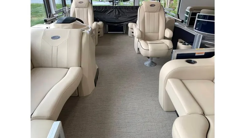 Slide: The Image of 2019 Barletta E20QC pontoon boat interior with beige seating and modern design. - 14