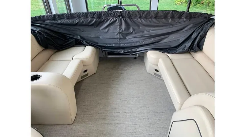 Slide: The Image of 2019 Barletta E20QC boat interior with beige seating and black cover. - 4