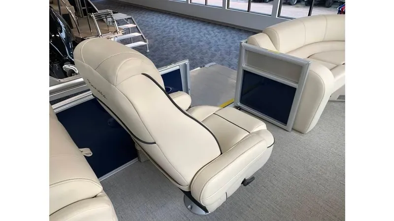 Slide: The Image of 2019 Barletta E20QC boat interior with beige seating and blue accents. - 6