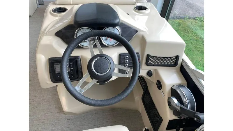 Slide: The Image of 2019 Barletta E20QC boat dashboard with steering wheel and controls. - 7