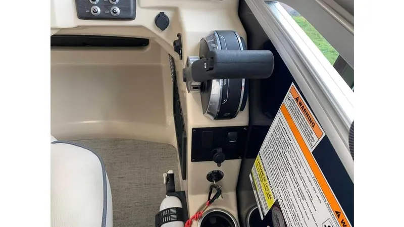 Slide: The Image of 2019 Barletta E20QC boat control panel with throttle and safety warnings. - 8
