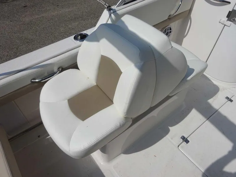Slide: The Image of 2023 Robalo R227 boat seat, white and beige upholstery, sleek design. - 11