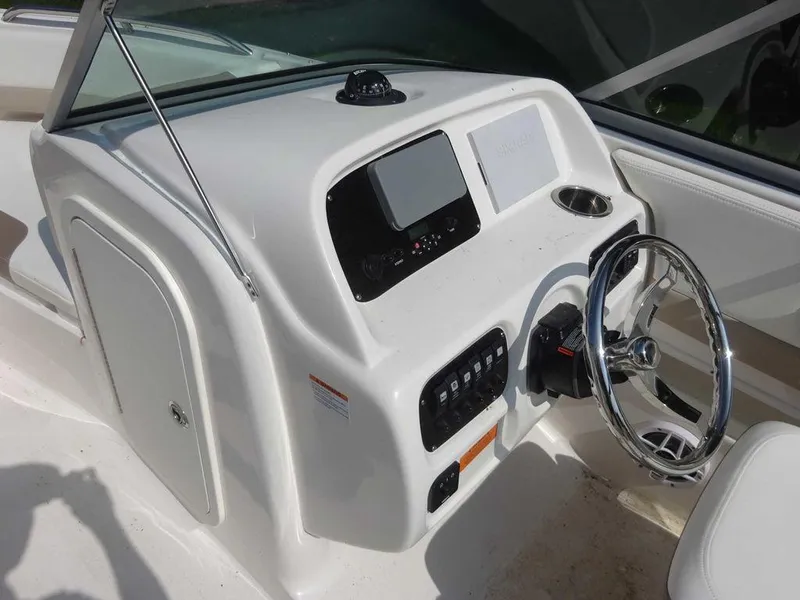 Slide: The Image of 2023 Robalo R227 boat dashboard with steering wheel and control panel. - 14