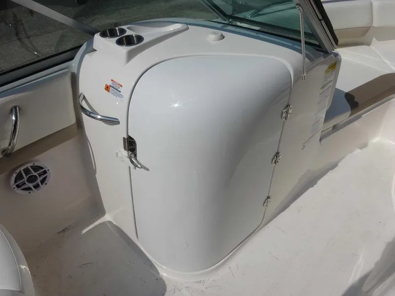 Slide: The Image of 2023 Robalo R227 boat interior with white console and cup holders. - 16