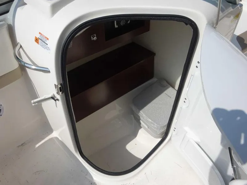 Slide: The Image of 2023 Robalo R227 boat storage compartment with seating and storage space. - 17