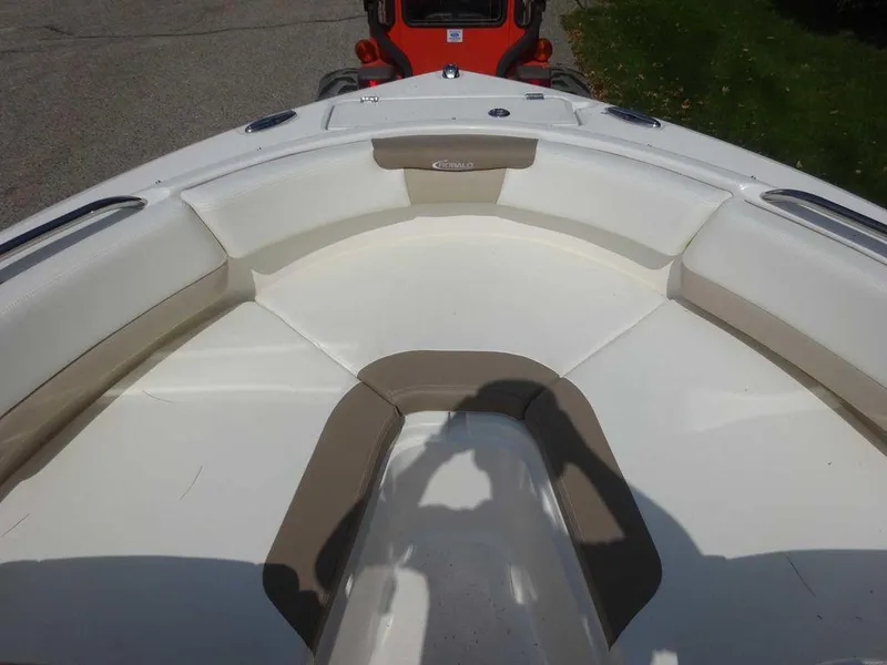 Slide: The Image of 2023 Robalo R227 boat interior with cushioned seating in white and beige. - 18