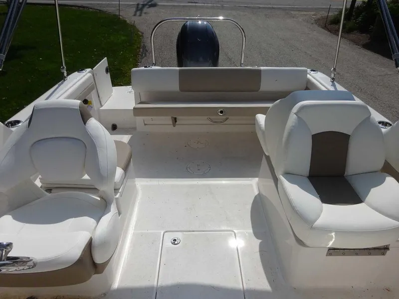 Slide: The Image of 2023 Robalo R227 boat interior with white seating and spacious deck layout. - 19
