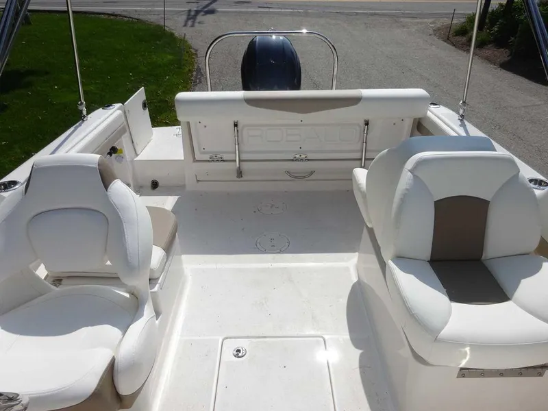 Slide: The Image of 2023 Robalo R227 boat interior with white seating and spacious deck layout. - 20