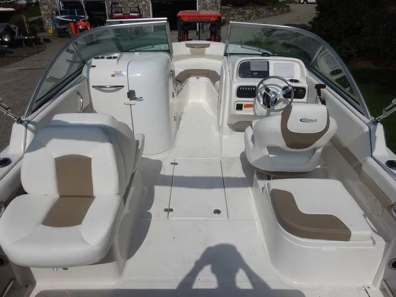 Slide: The Image of 2023 Robalo R227 boat interior with seating and steering console. - 6