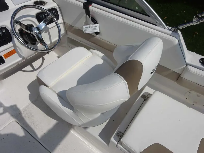 Slide: The Image of 2023 Robalo R227 boat interior with white seating and steering wheel. - 8