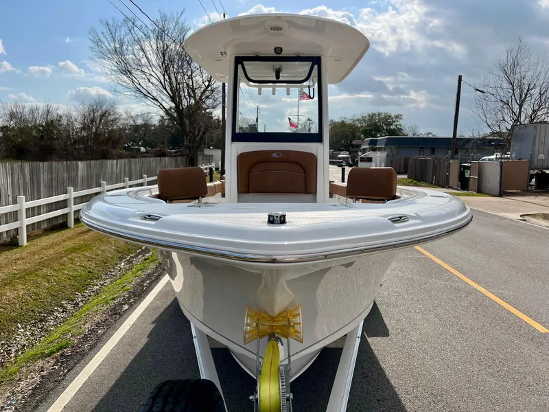 Slide: The Image of 2025 Sea Hunt Ultra 235 SE boat on trailer, parked on a road. - 6