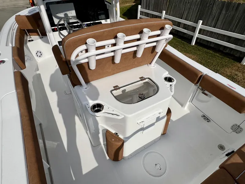 Slide: The Image of 2025 Sea Hunt Ultra 235 SE boat interior with rod holders and seating. - 8