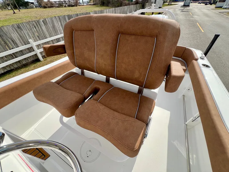 Slide: The Image of 2025 Sea Hunt Ultra 235 SE boat with brown cushioned seating. - 9