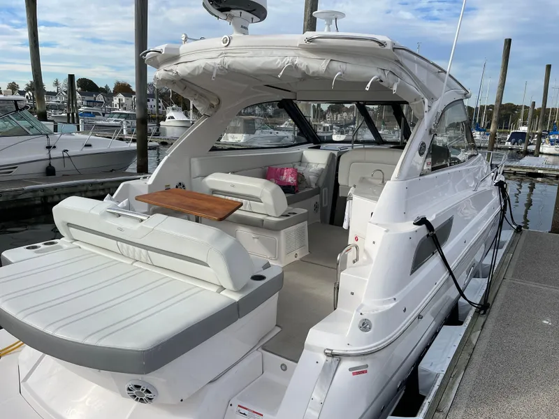 Slide: The Image of 2021 Regal 35 Sport Coupe yacht docked, featuring spacious seating and sleek design. - 10